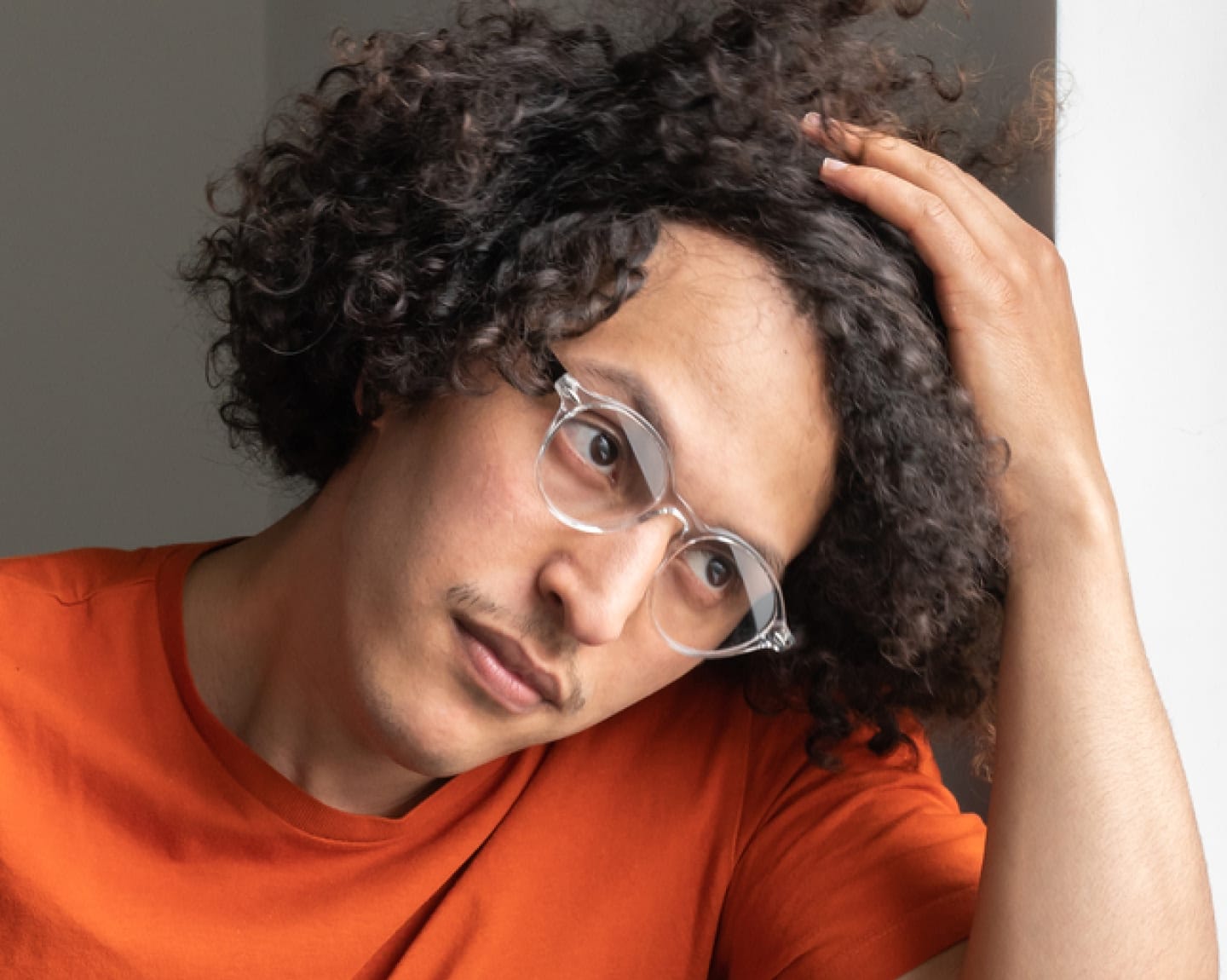 Man thinking and holding his hair back