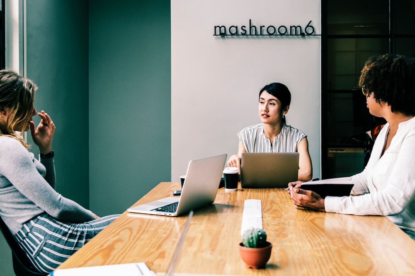 woman leading a meeting in a conference room