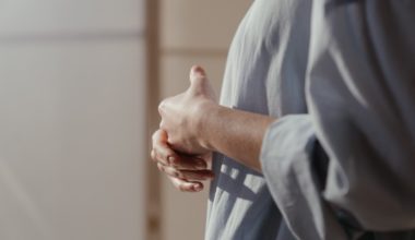 woman introspecting with interlaced hands.