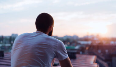 man sitting down facing away