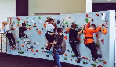 kids climbing up rock wall making progress