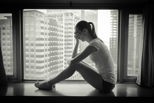 anxious woman in windowsill