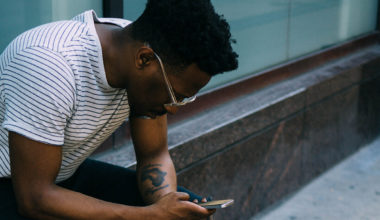 Man looking down at phone texting