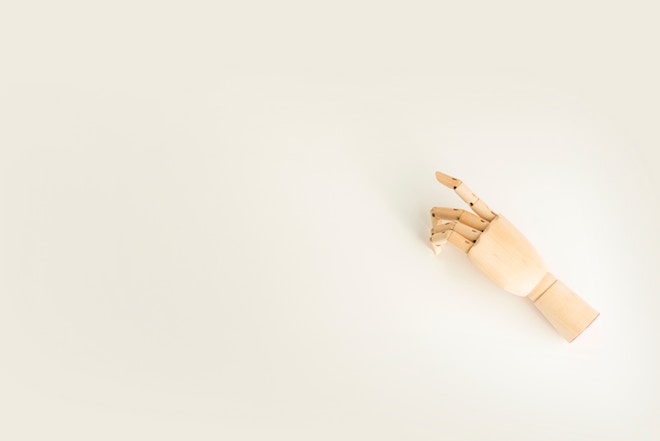 A wooden hand on a white background