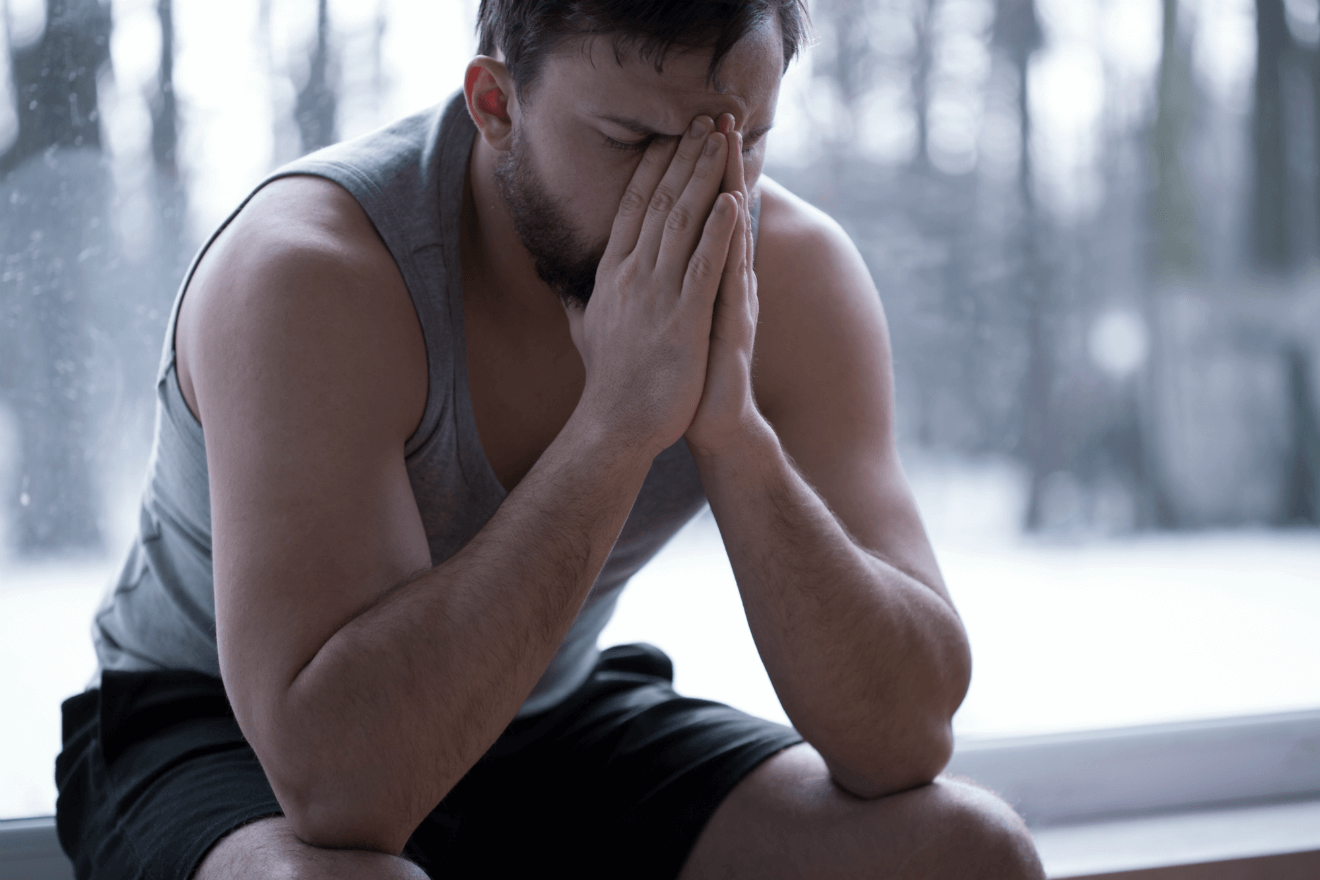 anxious man with head in hands