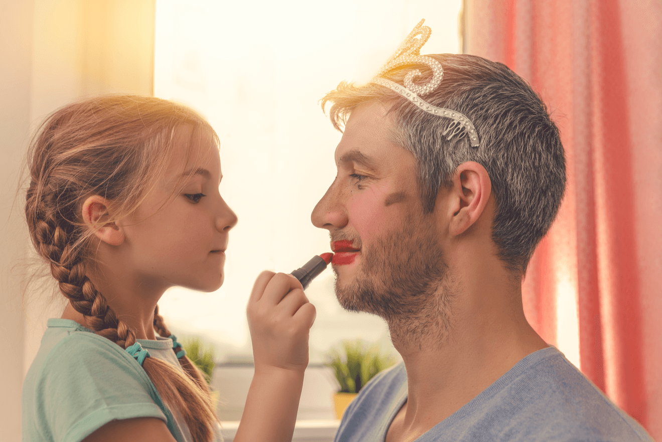 daughter putting lipstick on father