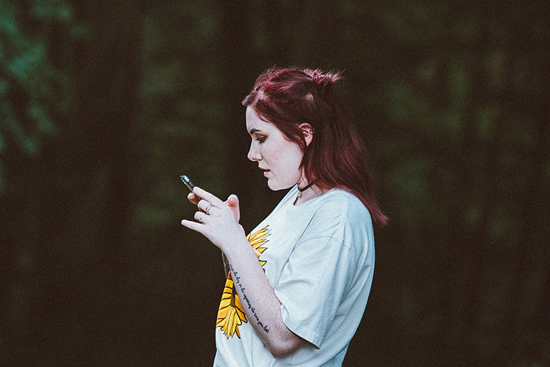 Woman on phone with sunflower shirt