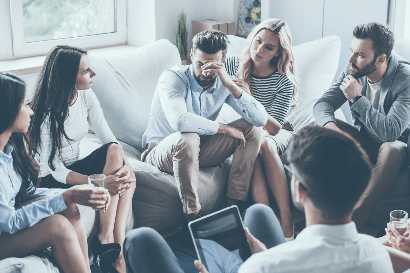 man with girlfriend her friends in living room
